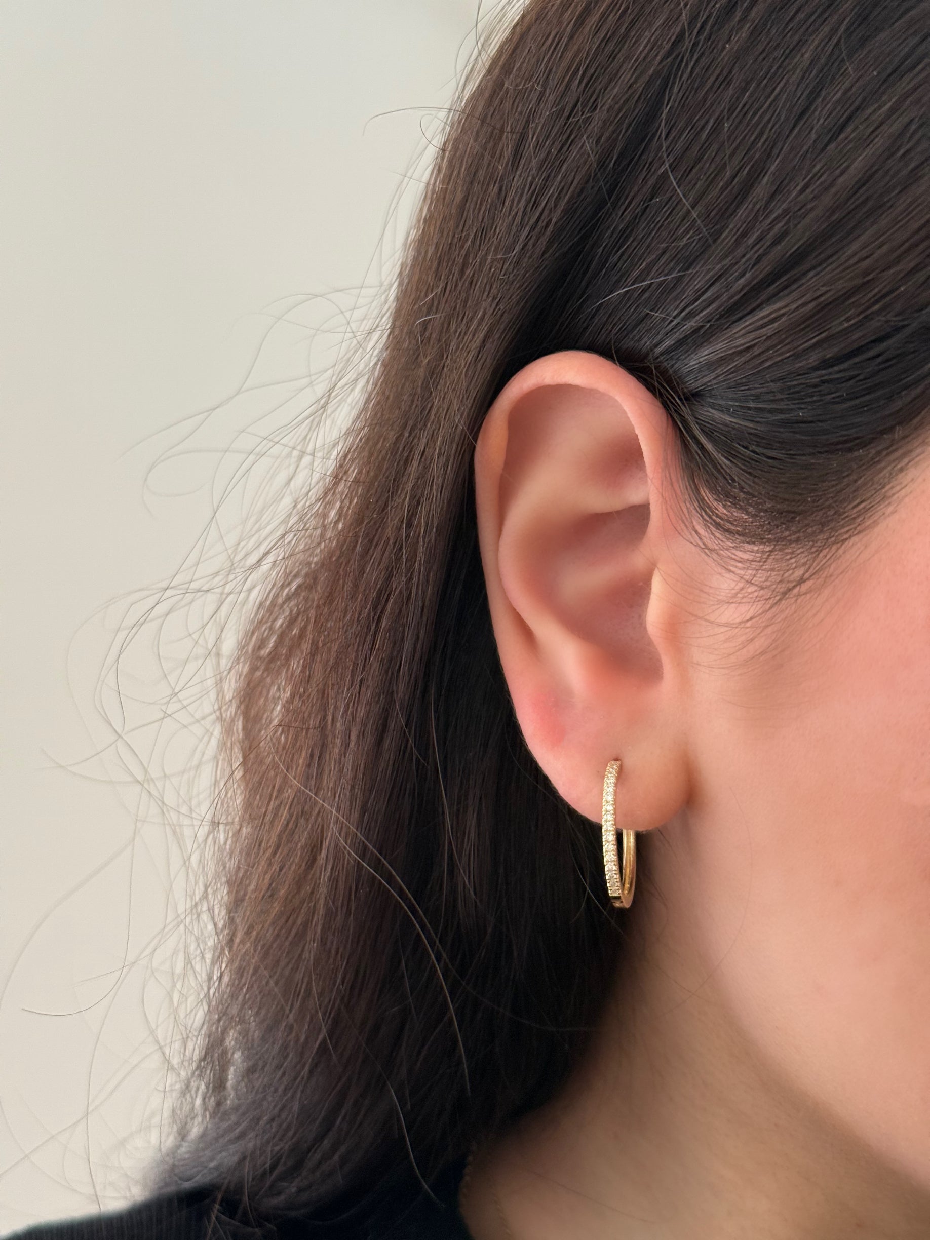 close up of girl wearing gold and lab diamond hoops