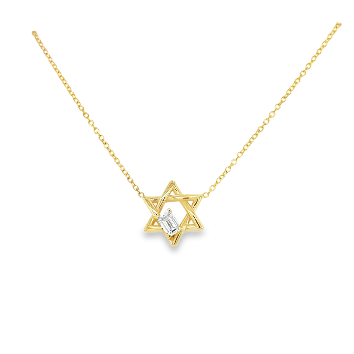 Gold necklace with a star-of-David pendant on a white background and emerald cut diamond embedded in the star