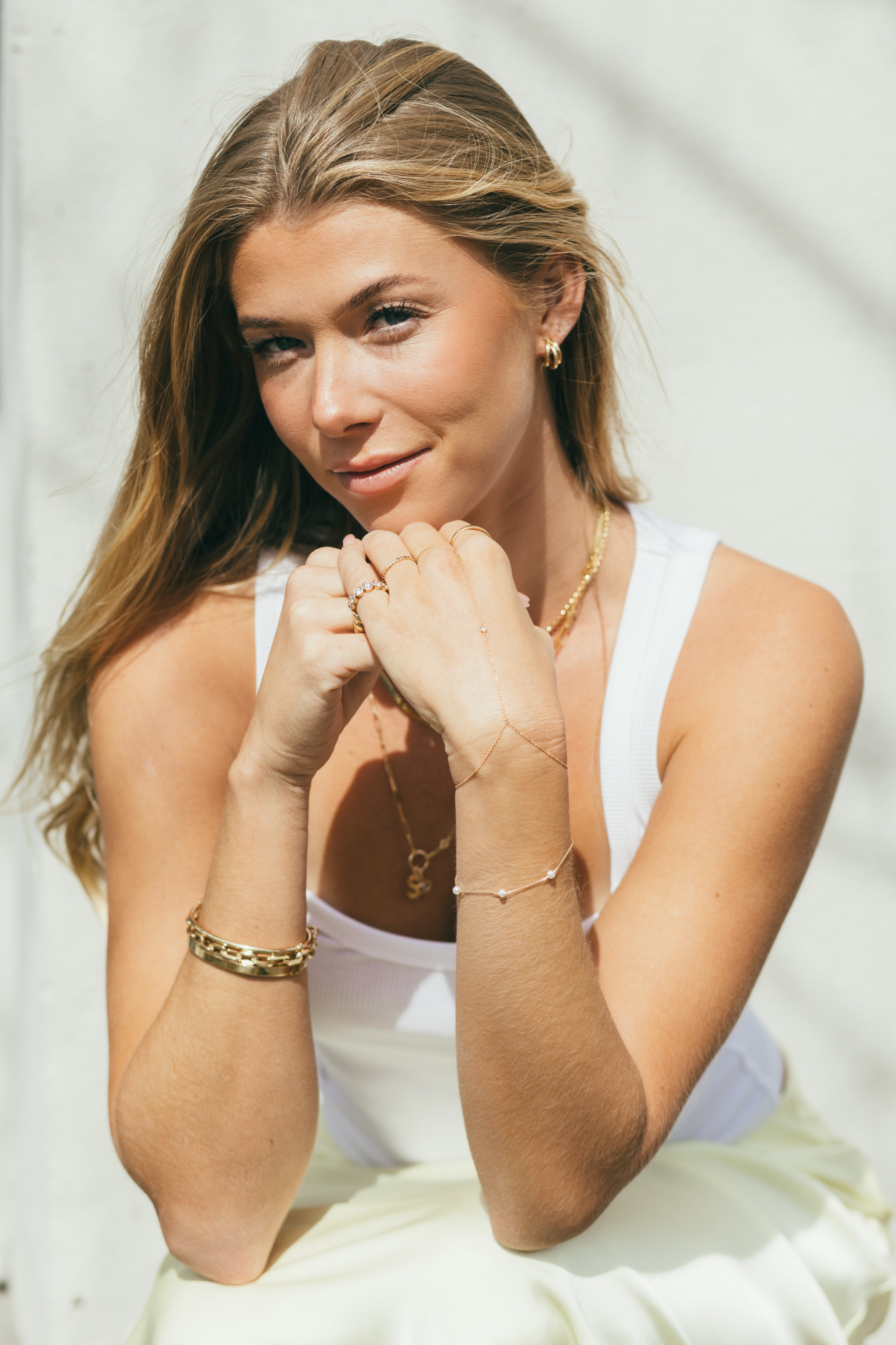 girl wearing multiple pieces of gold jewellery