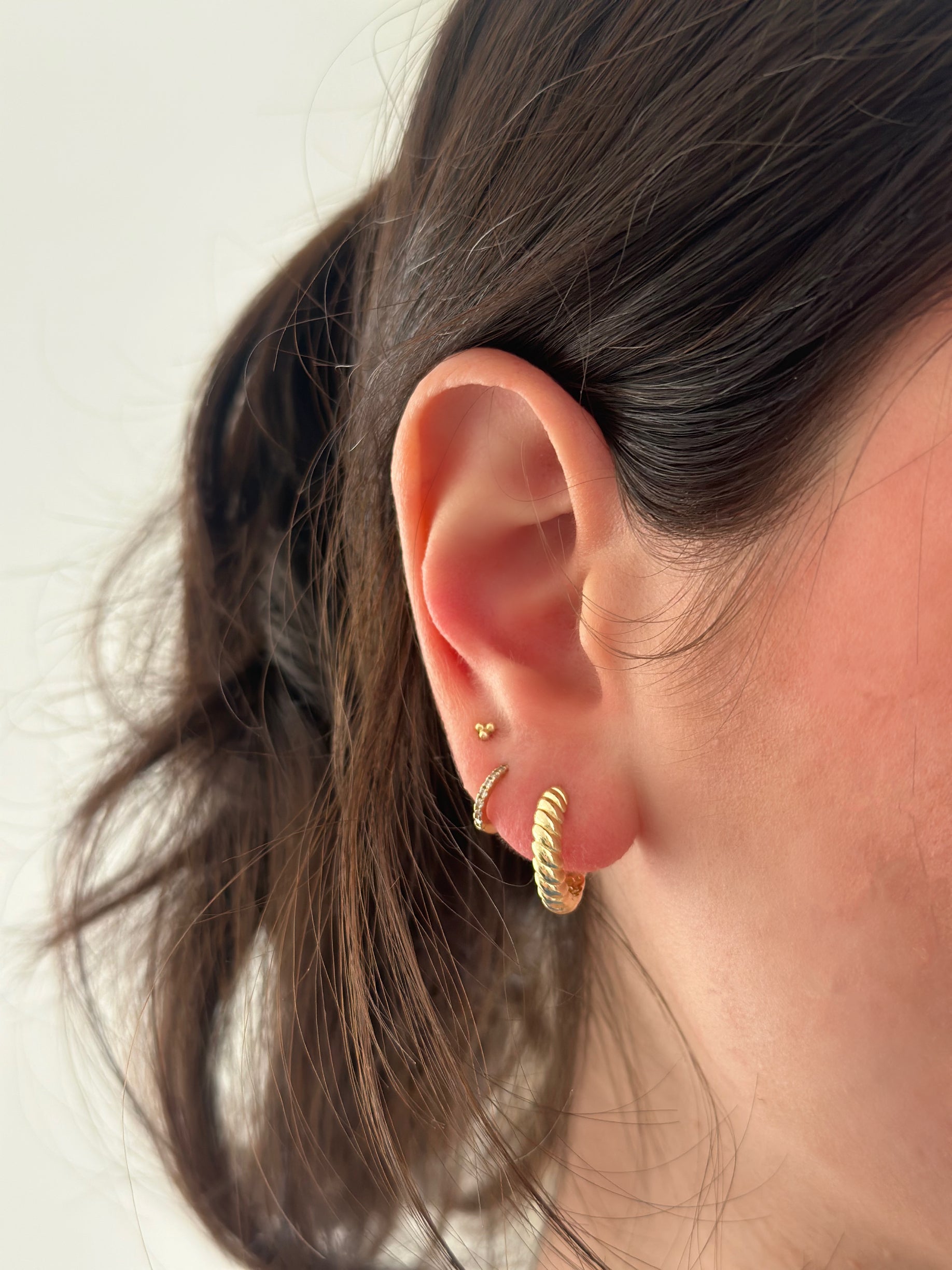 close up of ear wearing twisted huggies