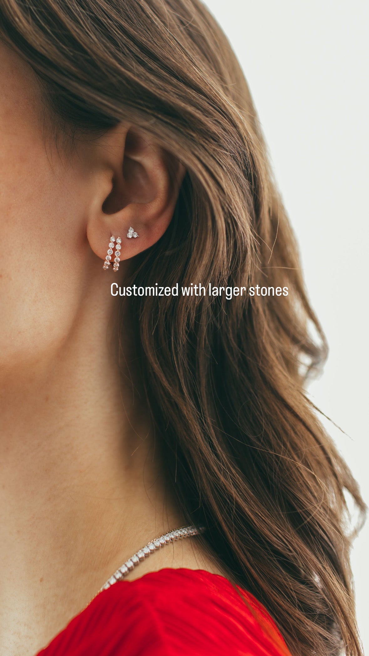 close up of customized larger rose gold double diamond huggie earrings