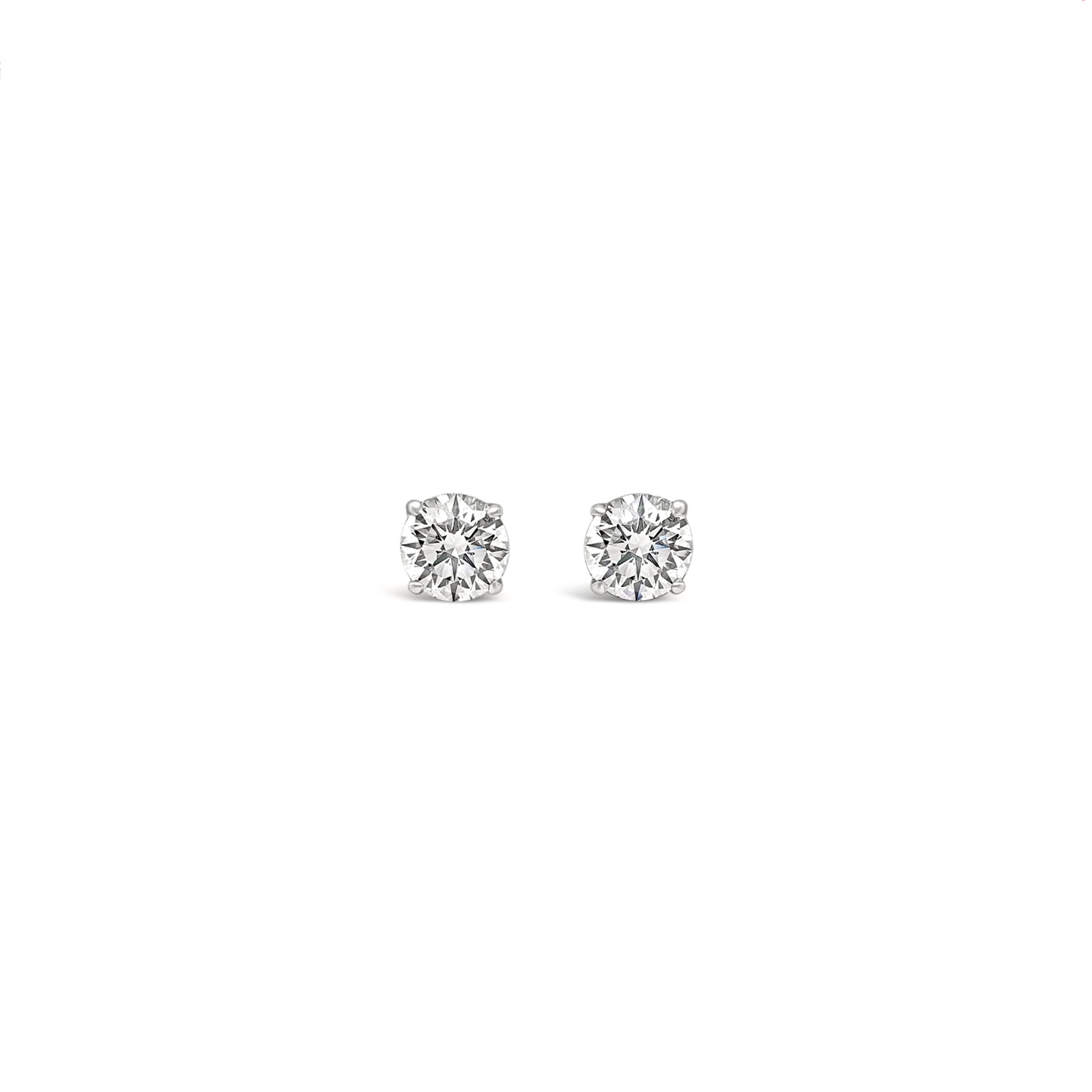 Pair of diamond stud earrings on a white background