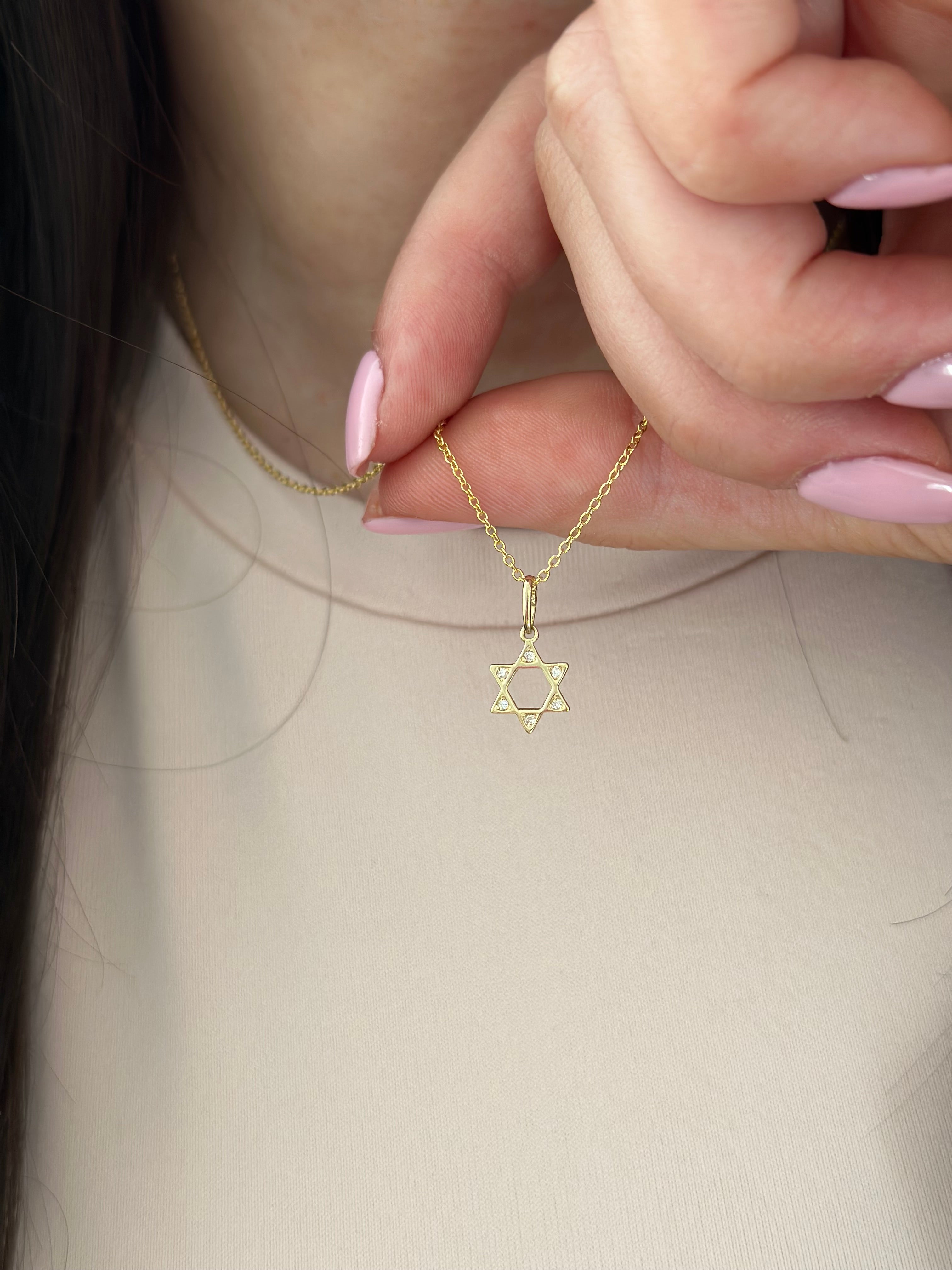 close up of dainty open diamond star of david pendant