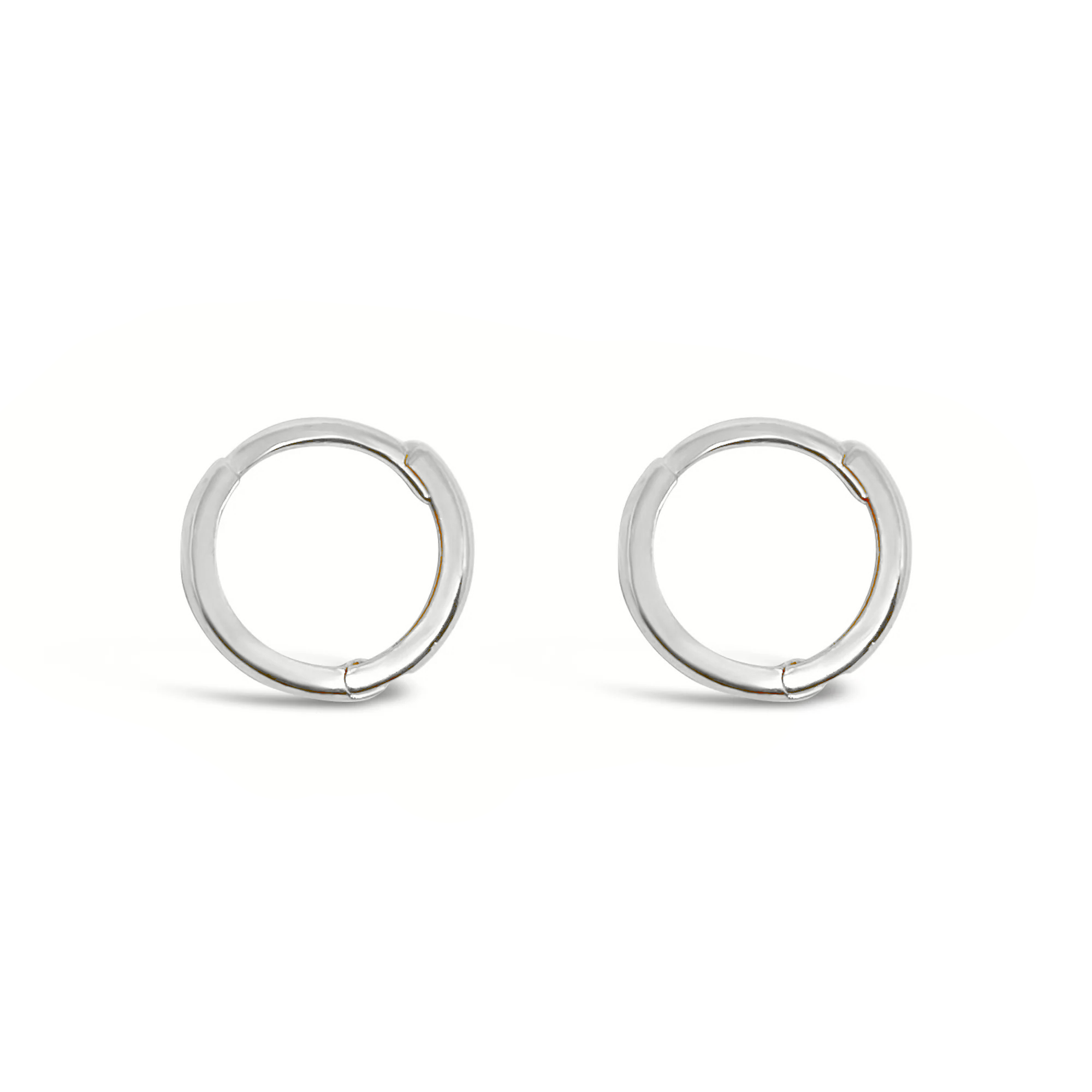 A pair of 14K gold mini huggie earrings on a white background