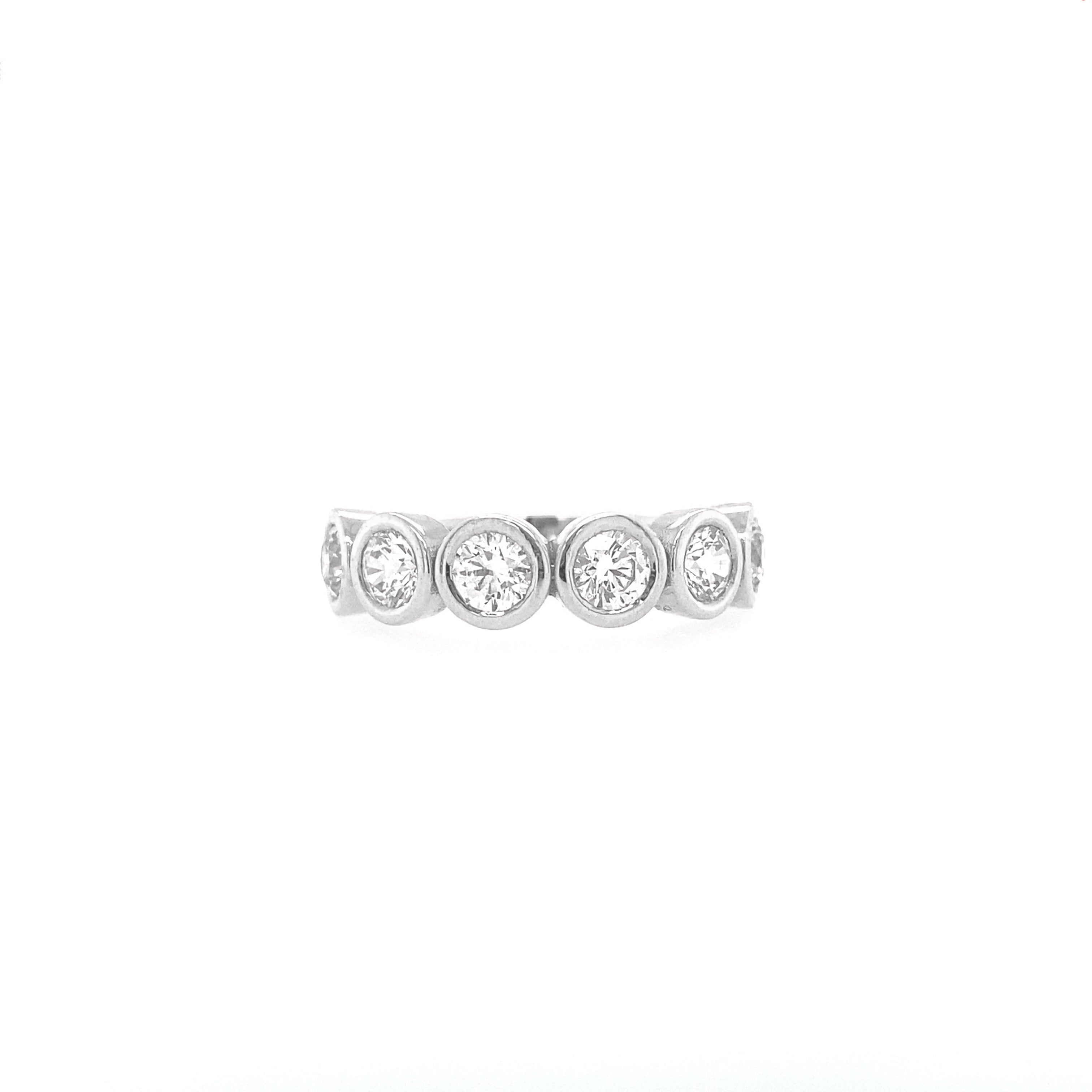 A white gold lab-grown diamond bezel ring with round diamonds on a white background.
