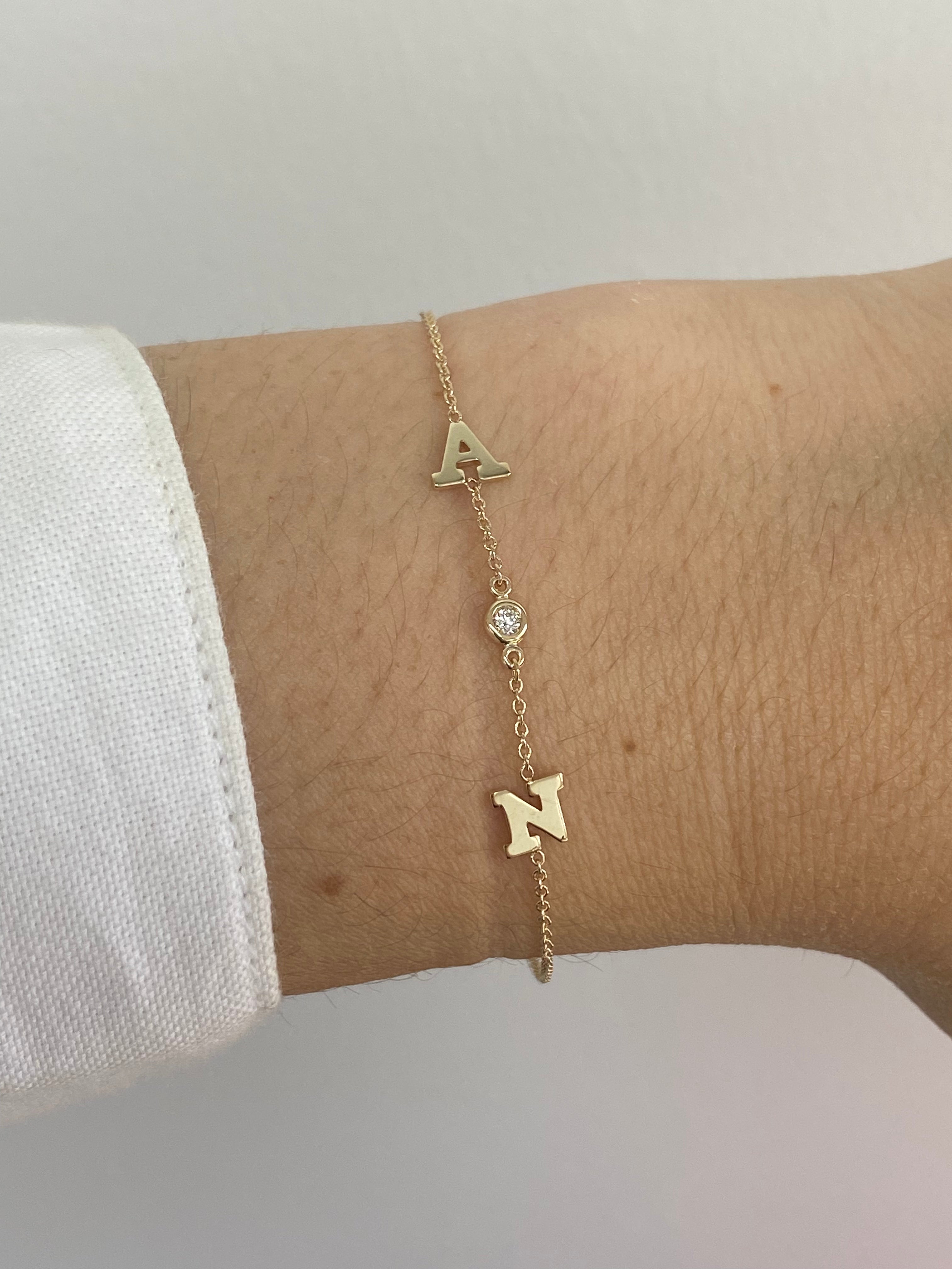 Detailed image of the Bold Initial and Diamond Bracelet from Jessica Jewellery, focusing on the serif font initials and interspersed diamonds on a fine gold chain.