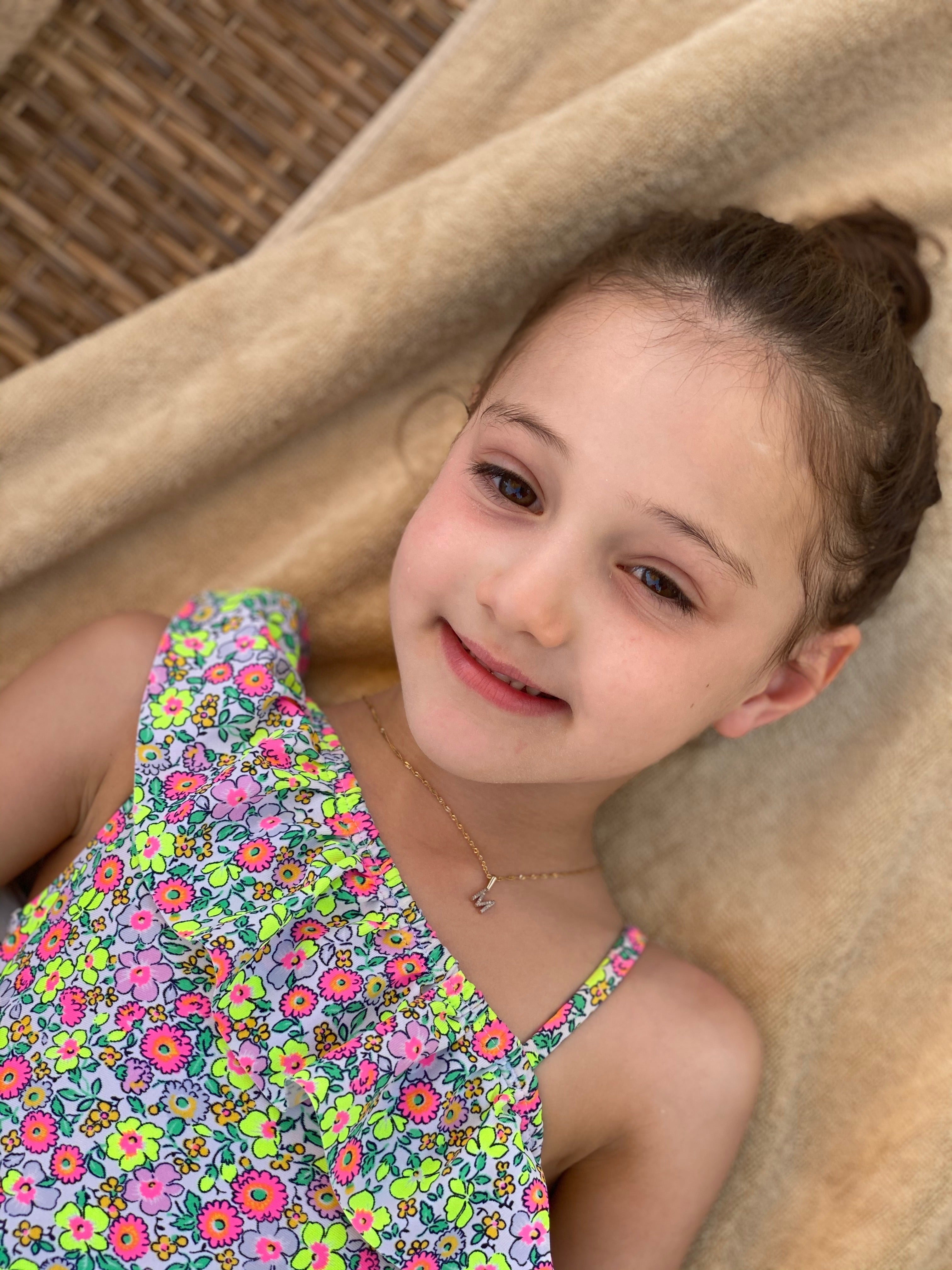 Detailed view of the diamond-encrusted initial charm by Jessica Jewellery.