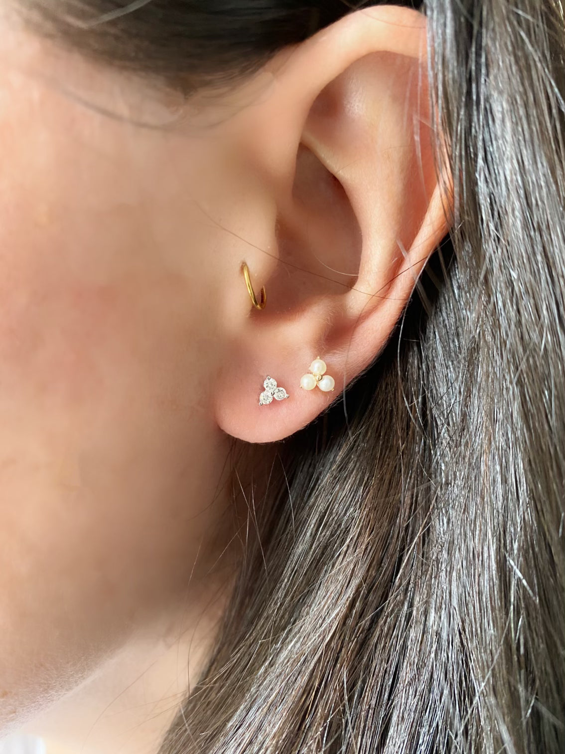 close up of diamond and pearl earring stack
