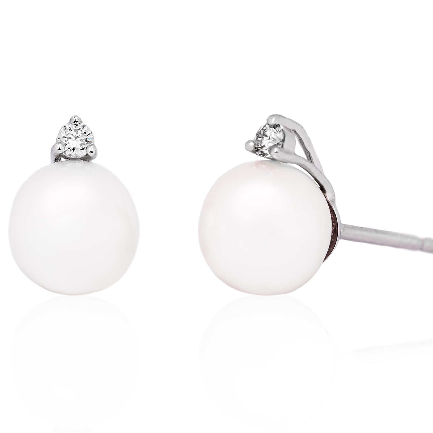 A pair of pearl and diamond stud earrings set in a white gold band.