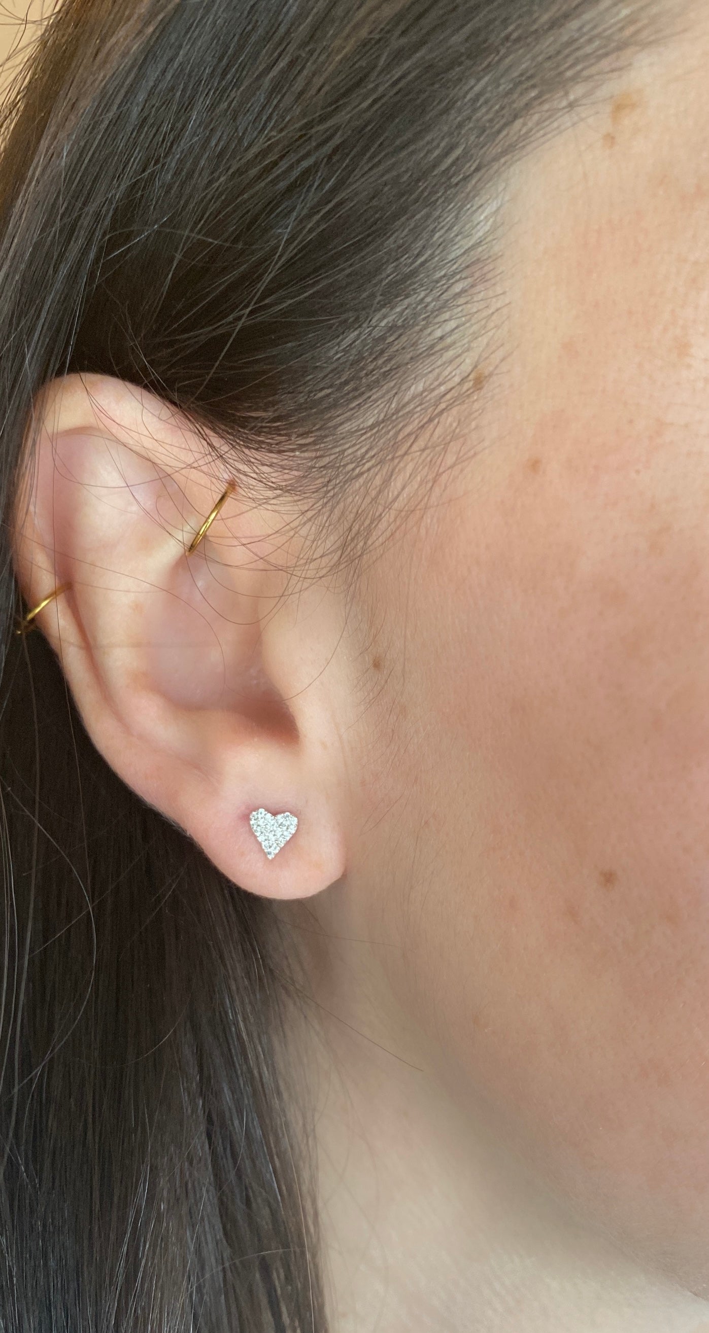 close up of girl wearing diamond heart studs