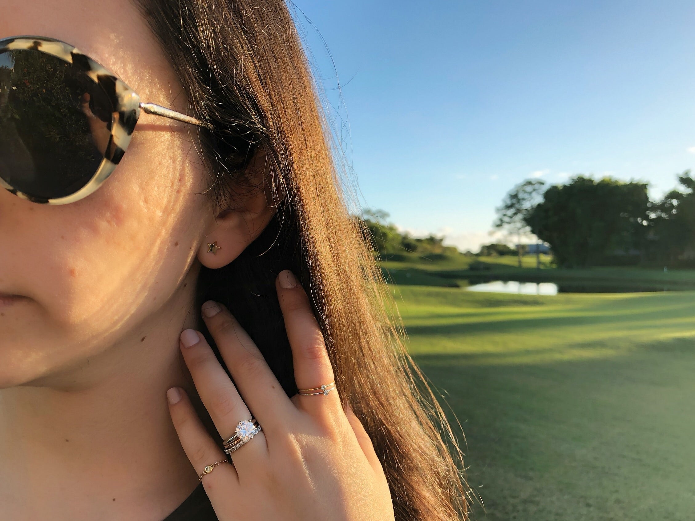 girl wearing engagement ring and white gold star studs