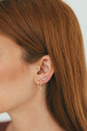 Model wearing Jessica Jewellery's Perfect Diamond Huggie Earrings with a chic, dangling diamond accent.