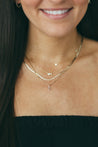 Elegant woman wearing Jessica Jewellery's diamond initial charm necklace.