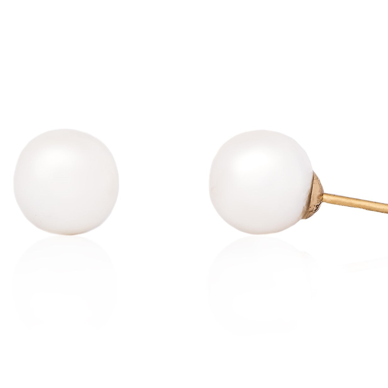 A pair of classic pearl stud earrings in 14K gold, showing the pearls attached to the earwires.