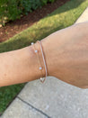 Lifestyle image of the Petite Pearl by the Yard Bracelet as a subtle yet chic accessory.