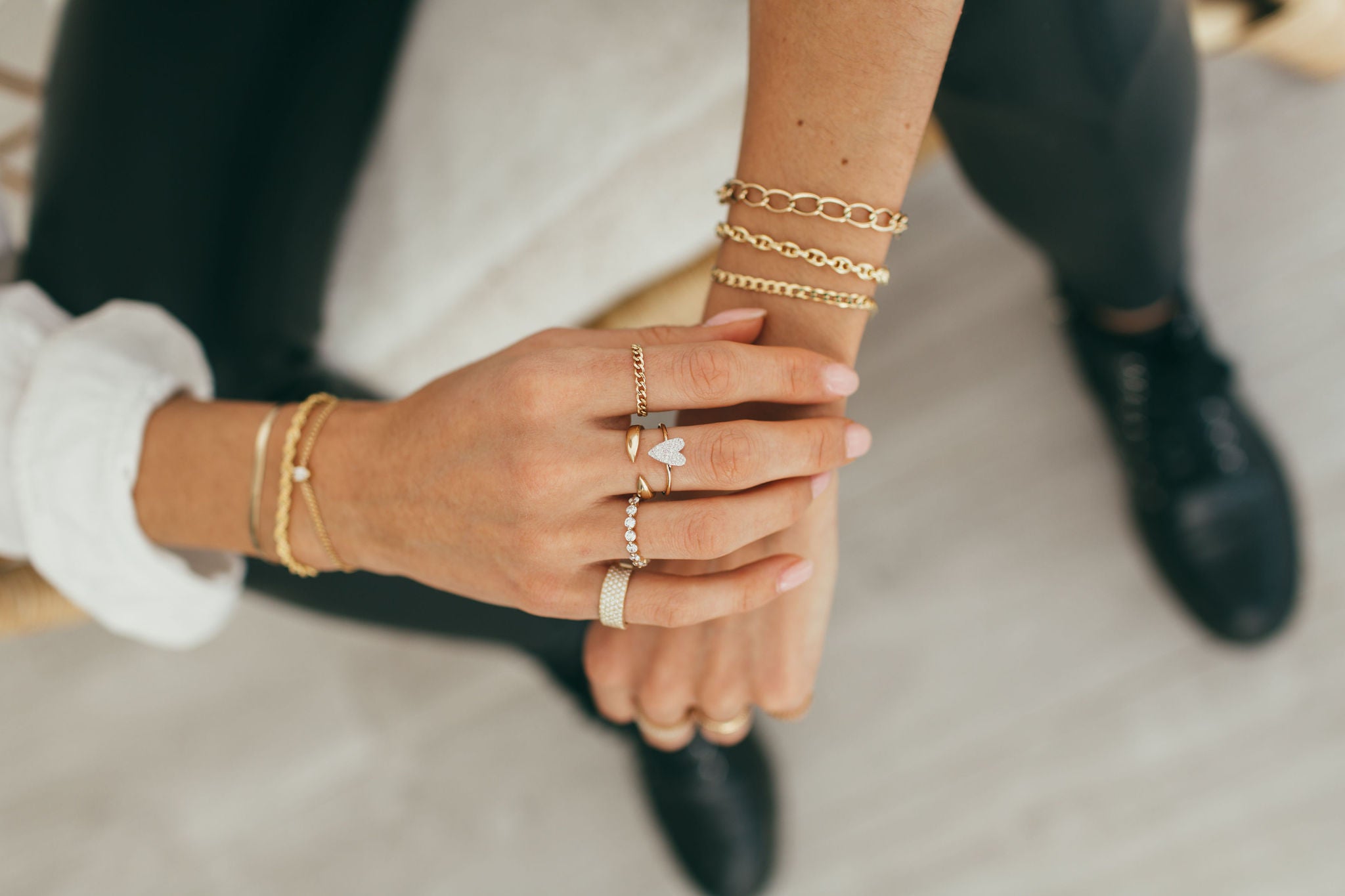 woman wearing diamond and gold jewelry - diamond ring and gold bracelet