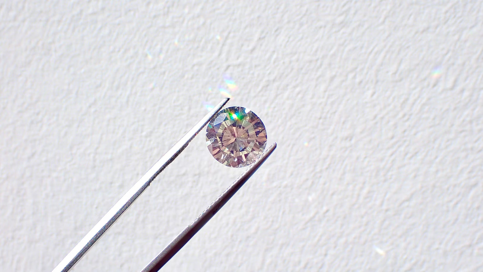 diamond held with tweezers