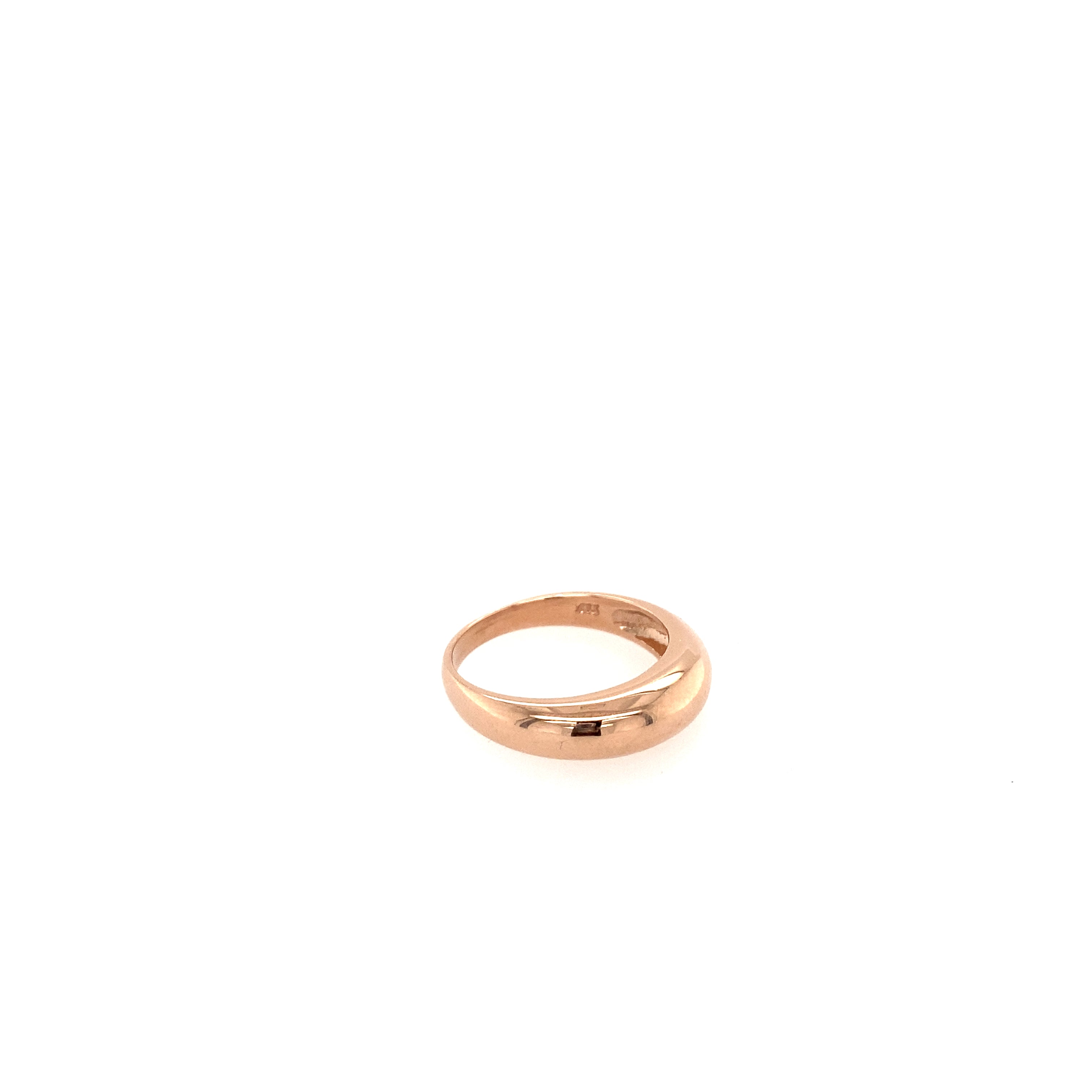 A side view of a rose gold chunky dome ring on a white background.