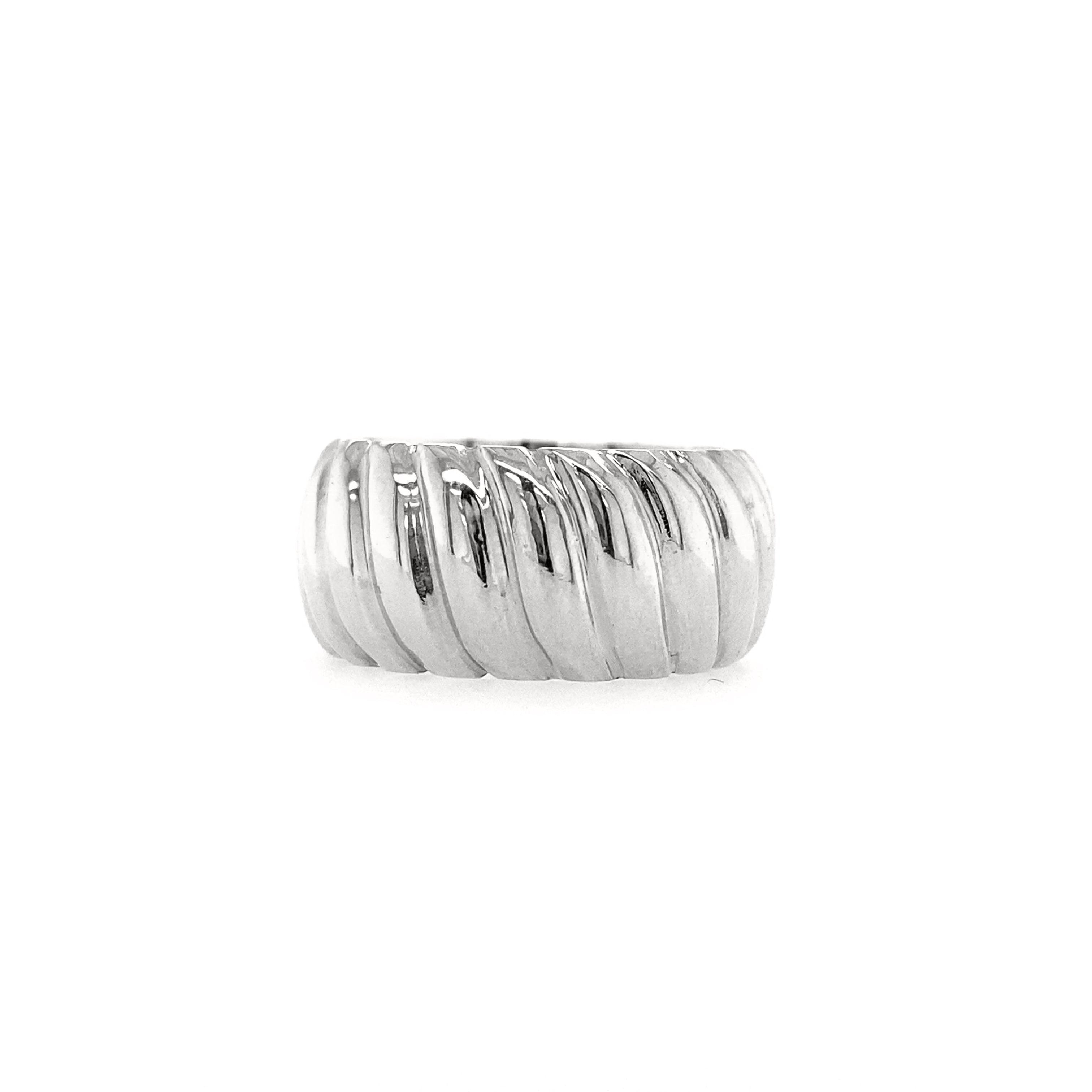 A white gold chunky wide croissant ring against a white background.