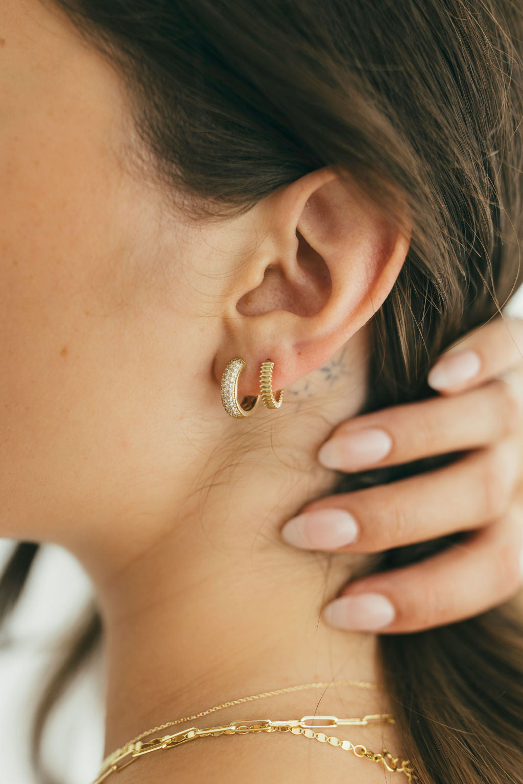 close up shot of diamond and gold earring stack