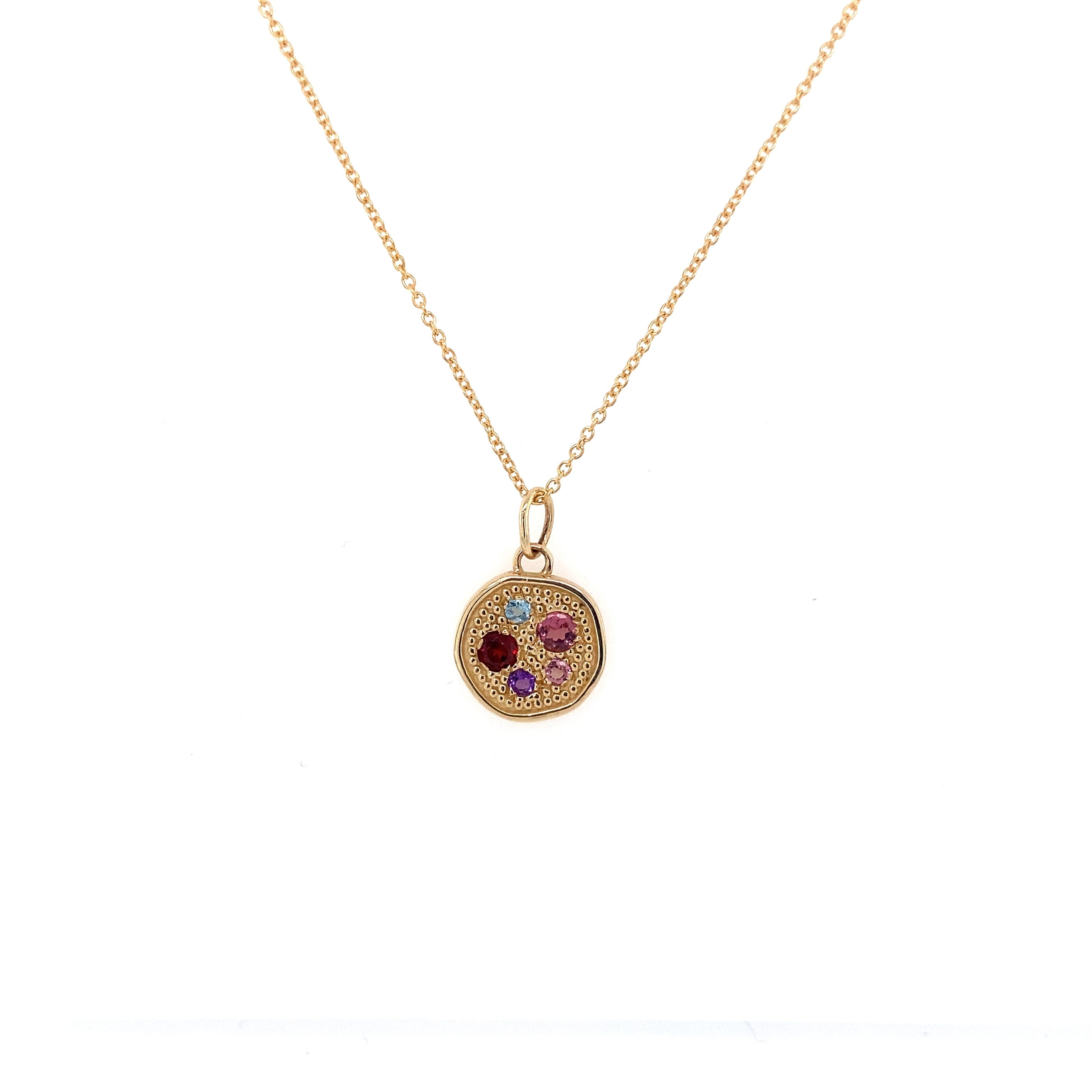A 14 karat gold personalized family birthstone pendant with a circular design featuring a mix of colored gemstones arranged in a pattern.