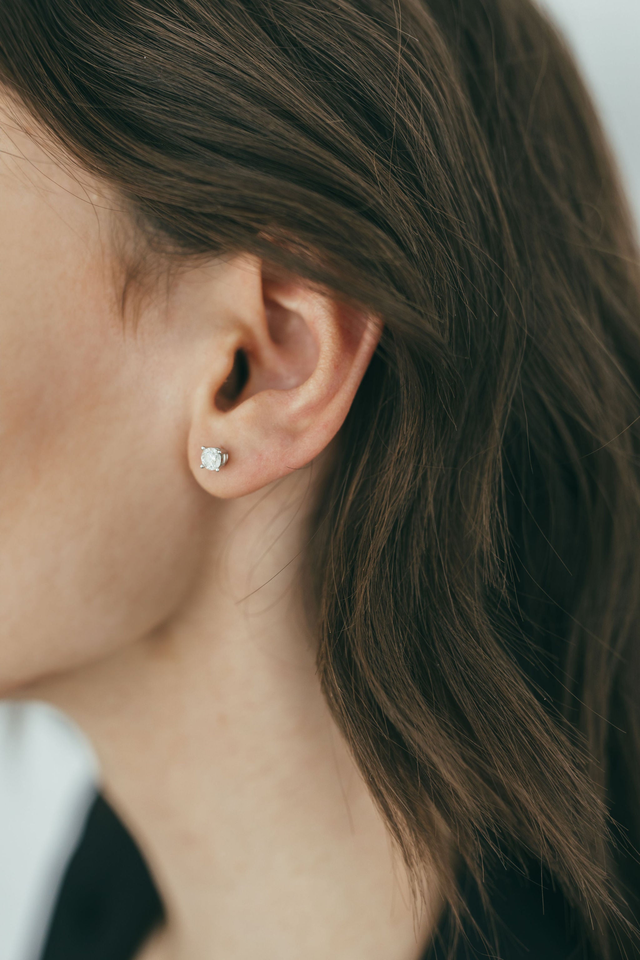 close up of ear wearing double gallery lab grown diamond studs