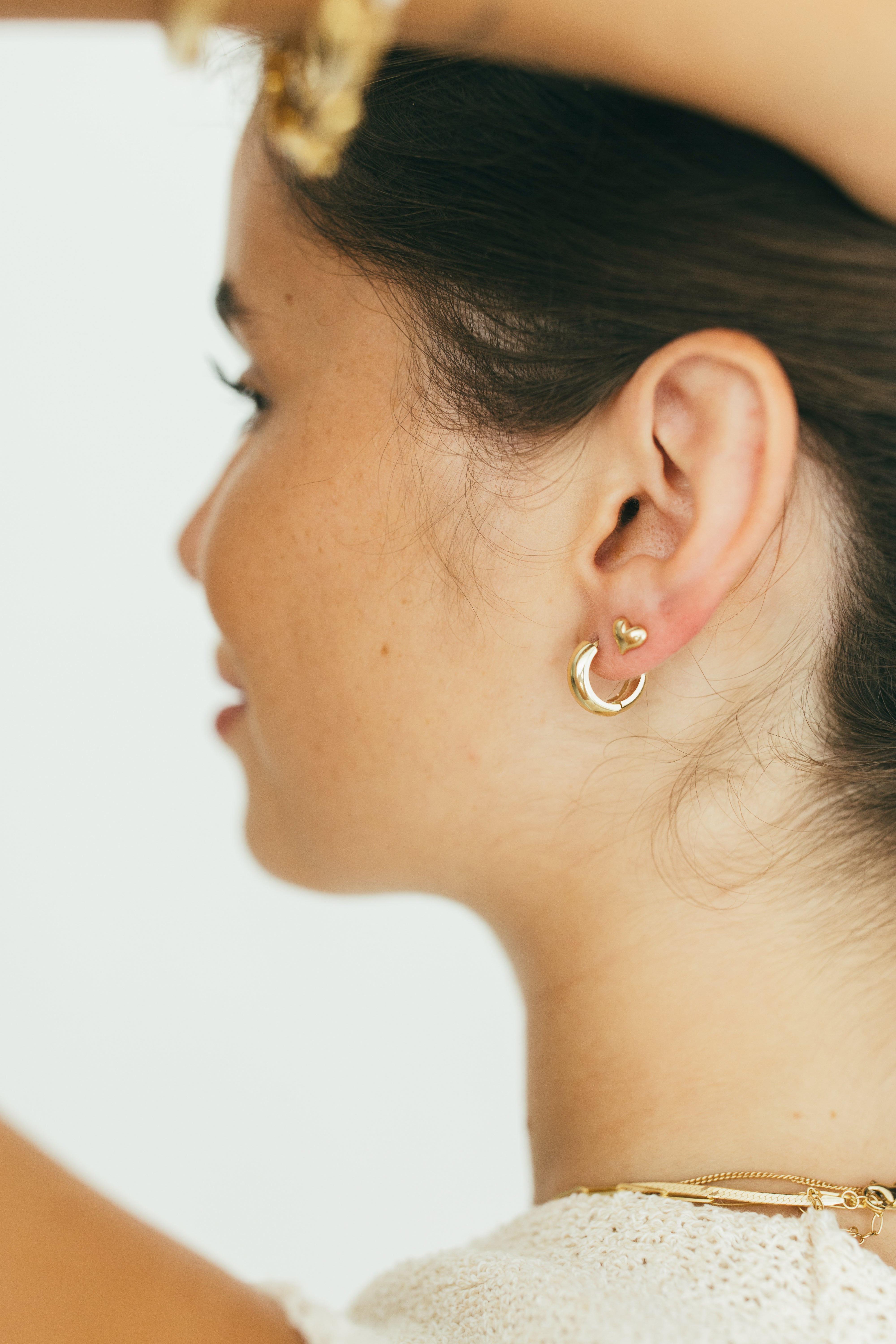 close up of girls ear with heart studs