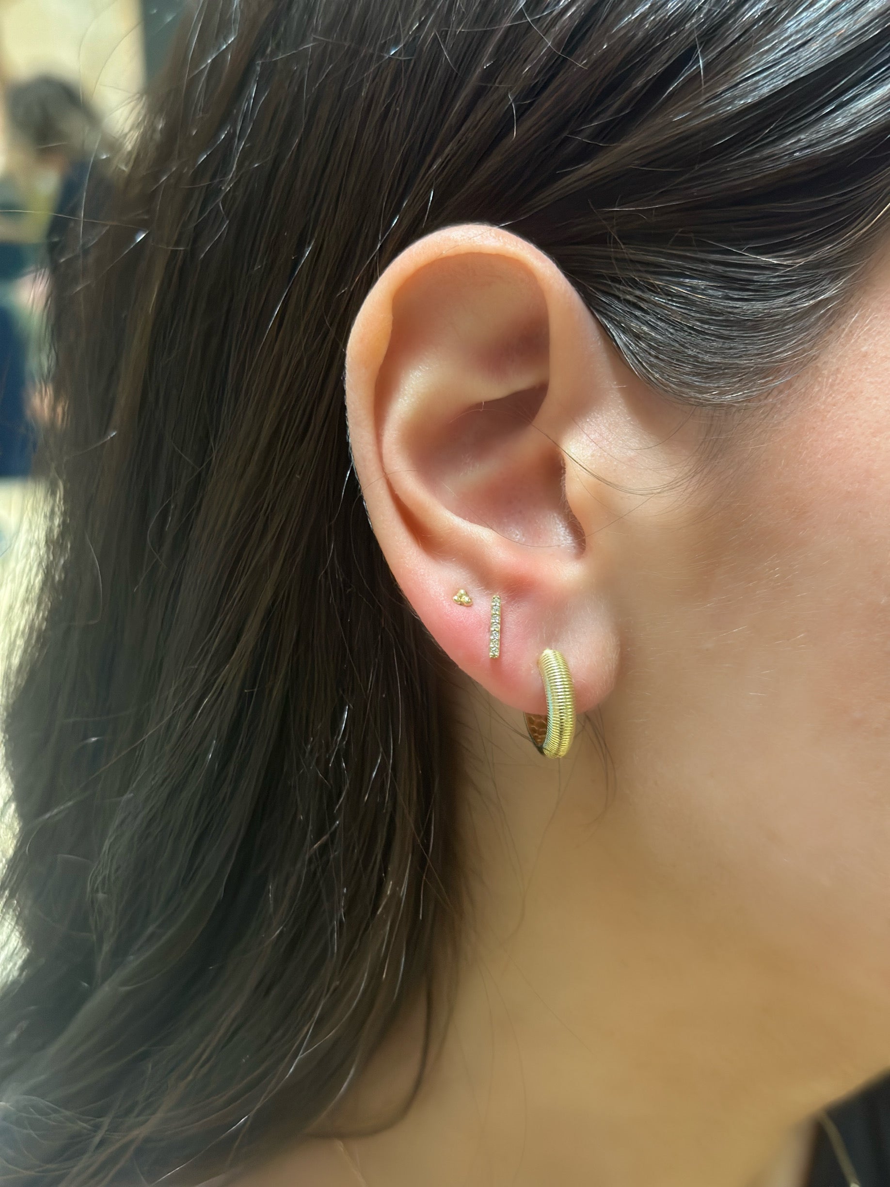 close up of gold and diamond earring stack