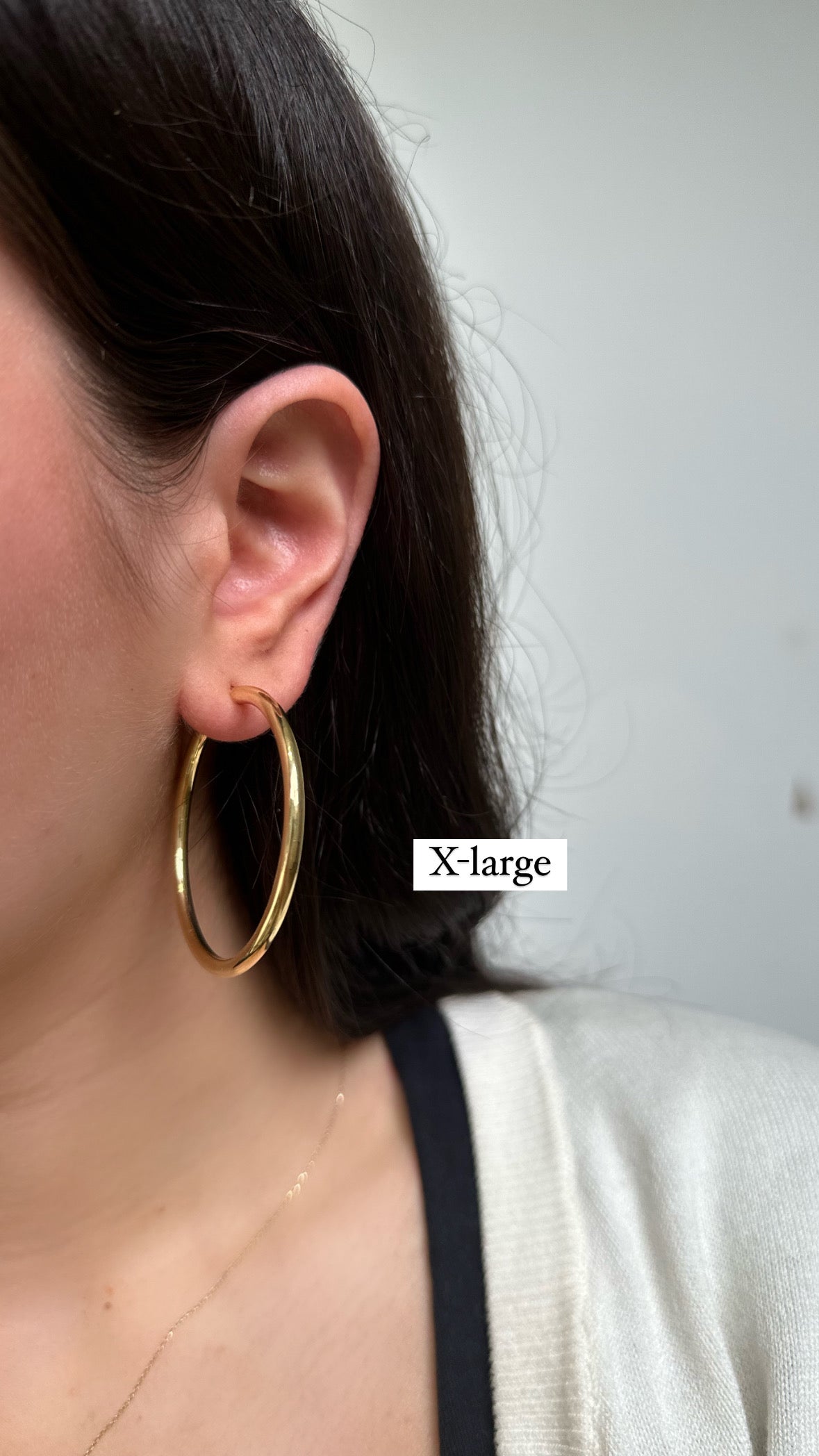 girl wearing gold hoops in an extra large size