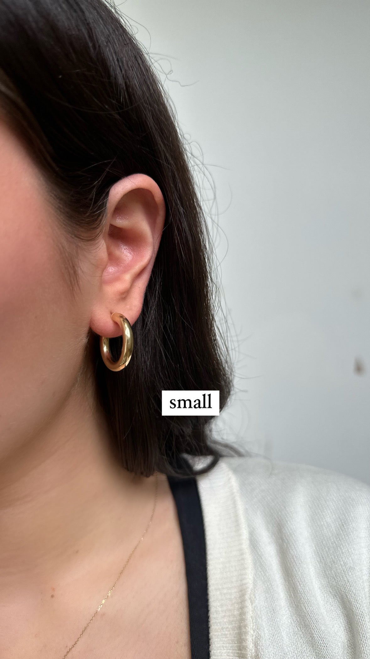 close up of ear earring gold small hoops