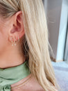 Jessica Jewellery's Diamond Huggie Earrings shown on model, demonstrating versatility with casual and formal attire.