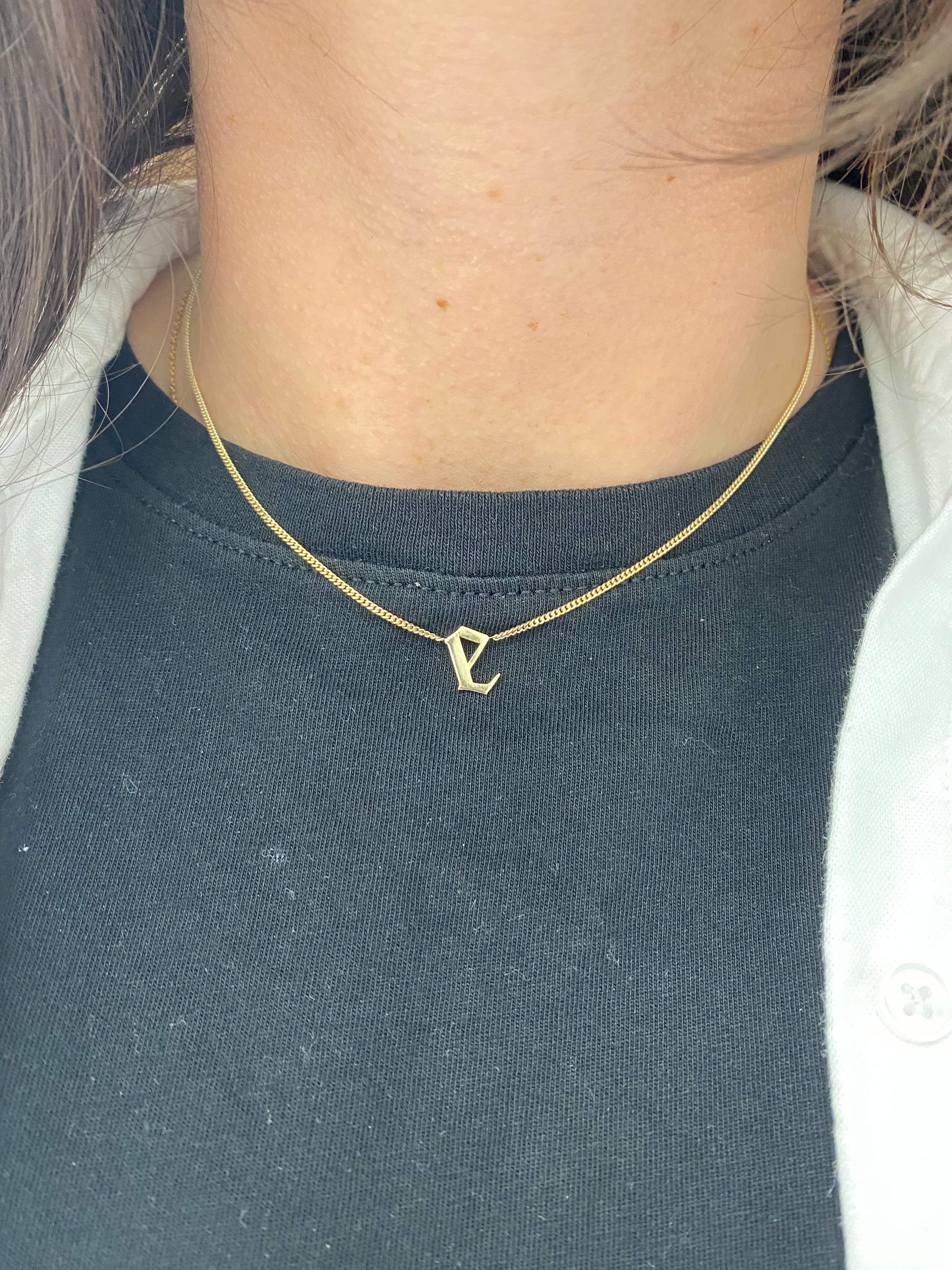 Elegant and bold Gothic Initial Necklace worn alone for a statement look.