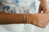 Jessica Jewellery's diamond cut puffy curb bracelet styled on wrist.