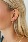 Elegant ear stack featuring Jessica Jewellery's Diamond Huggie Earrings alongside delicate gold hoops.