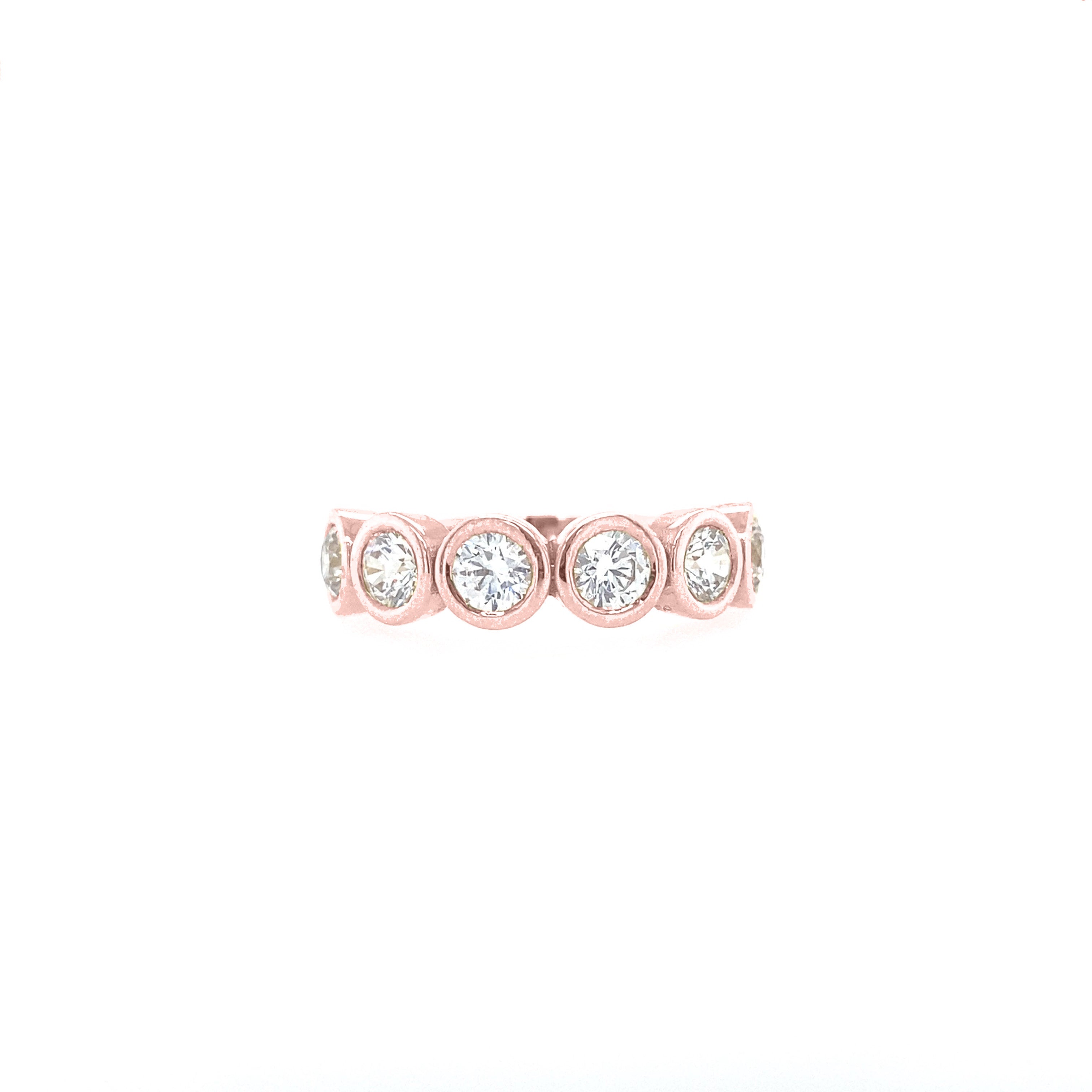 A rose gold diamond bezel ring on a white background.