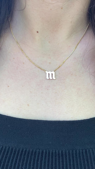 Fashionable gold curb necklace with Gothic initial, great for personalized style.