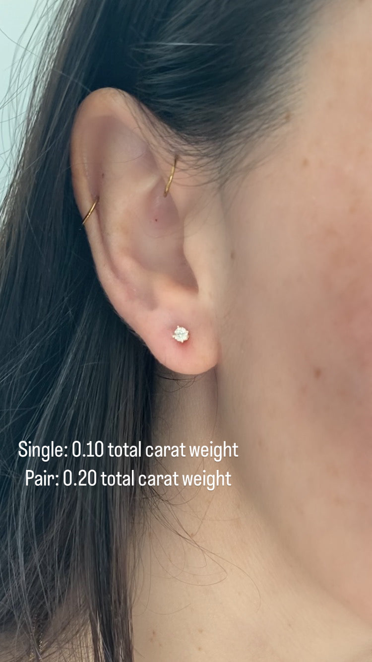 close up of girls ear wearing .10 total carat weight diamond stud