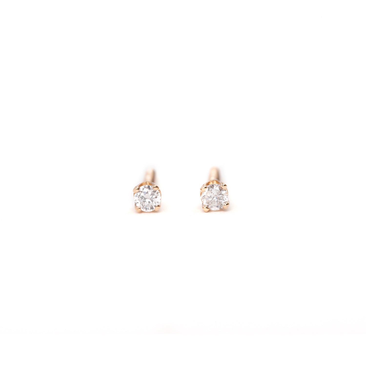A pair of 14K gold mini diamond stud earrings with screw back closure, displayed against a white background.