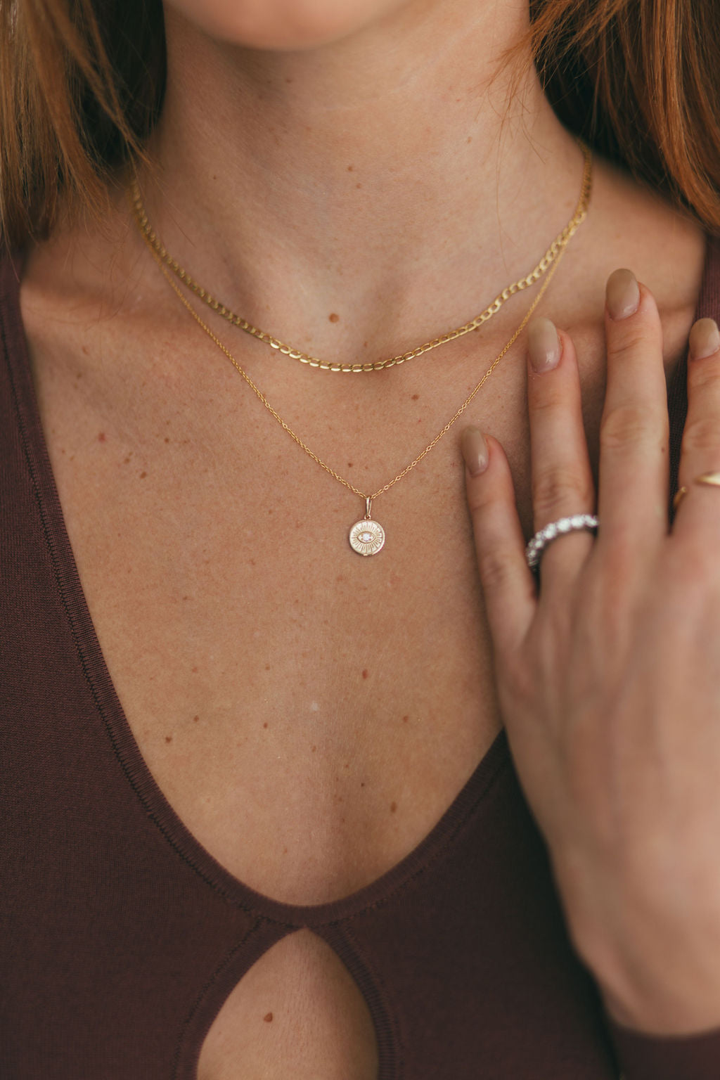Close-up of Diamond Evil Eye Medallion on model's neck