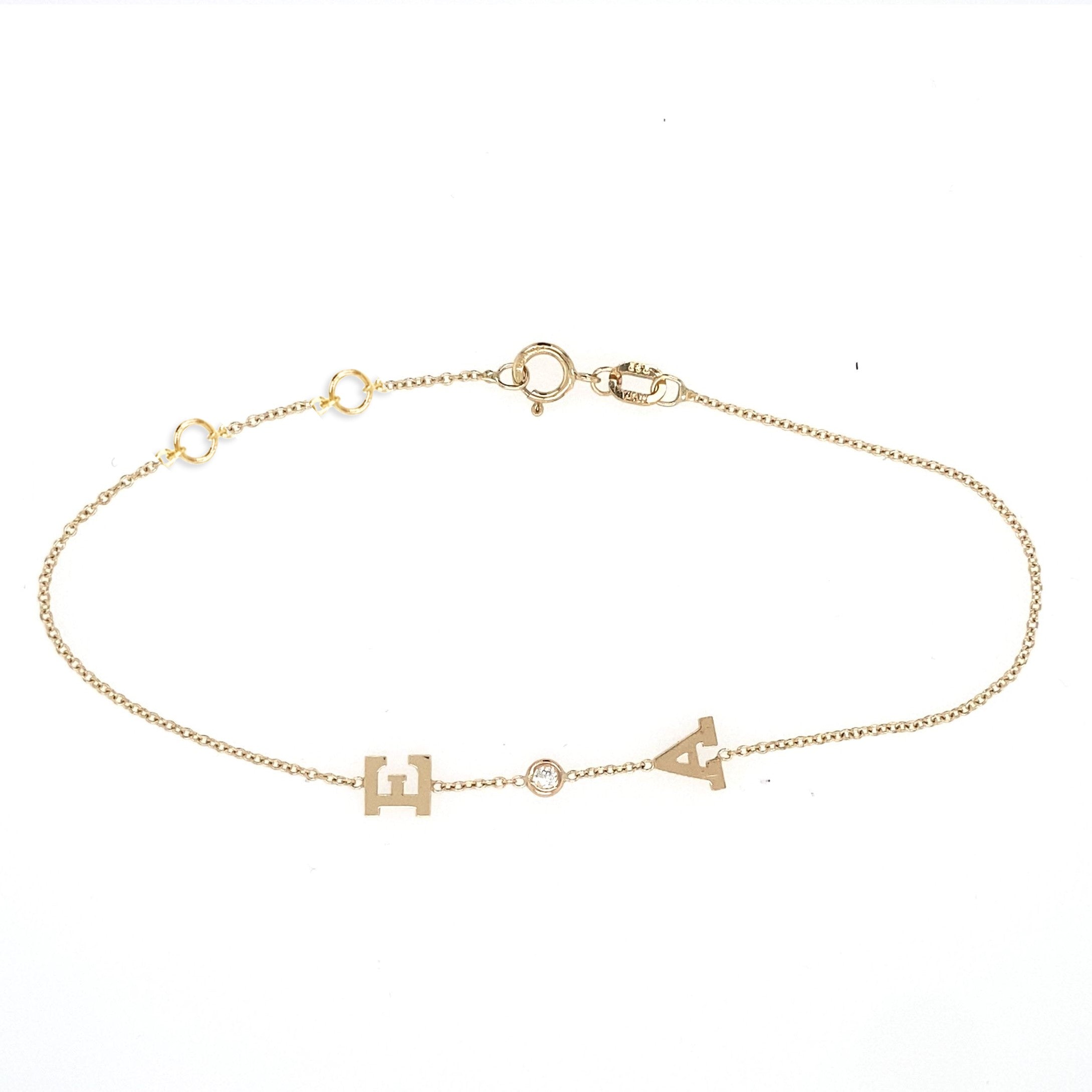 Jessica Jewellery's custom Bold Initial and Diamond Bracelet in 14 karat gold, showcasing personalized initials alternated with brilliant diamonds.