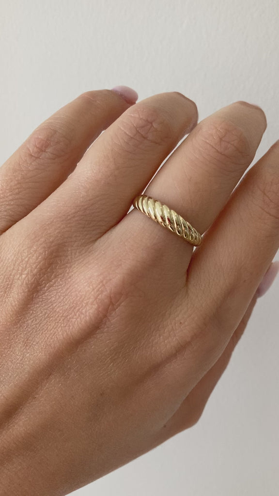 Jessica Jewellery's small croissant ring featured in a minimalist jewelry setup, emphasizing its unique design.