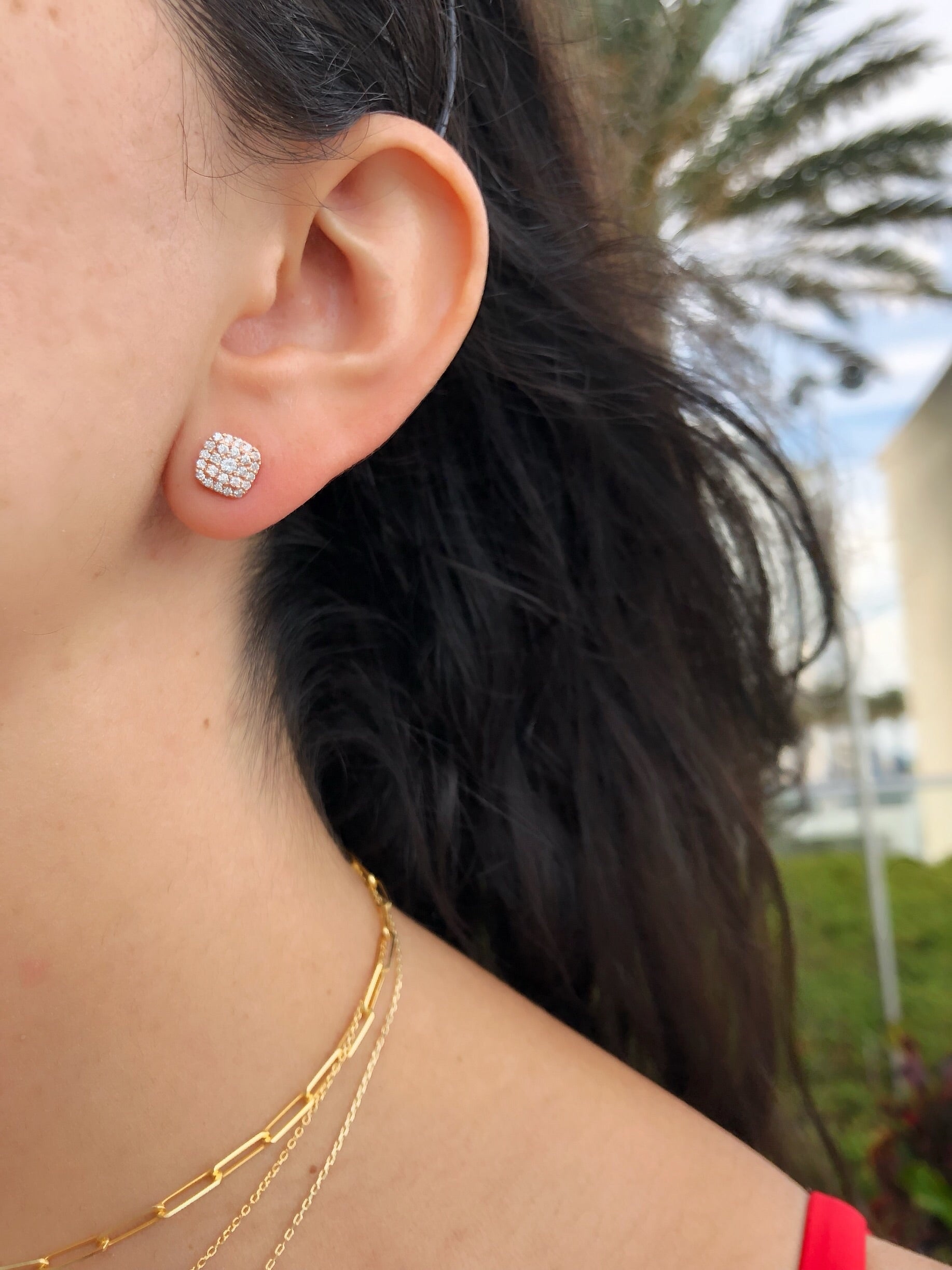 close up of ear wearing diamond cluster studs