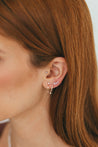 Model's profile highlighting the sparkle of Diamond Huggie Earrings with dangling diamond, perfect for evening wear.