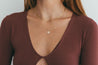 Close-up of Diamond Evil Eye Medallion on model's neck