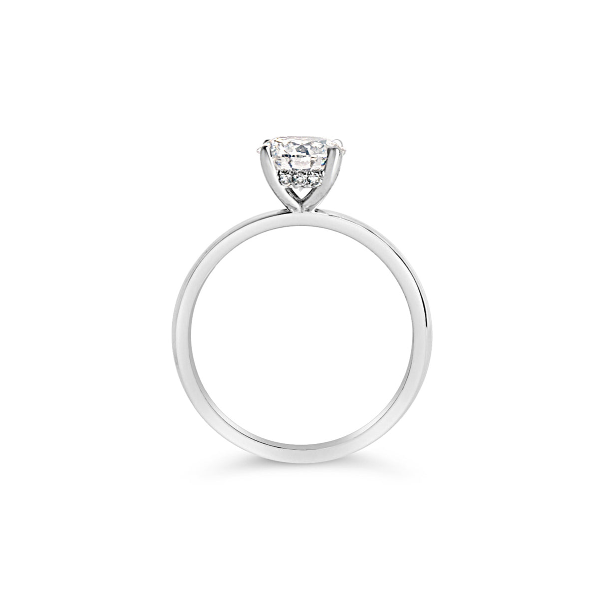 A solitaire engagement ring featuring a hand-picked center diamond with a hidden halo of small diamonds hidden just beneath the main stone.