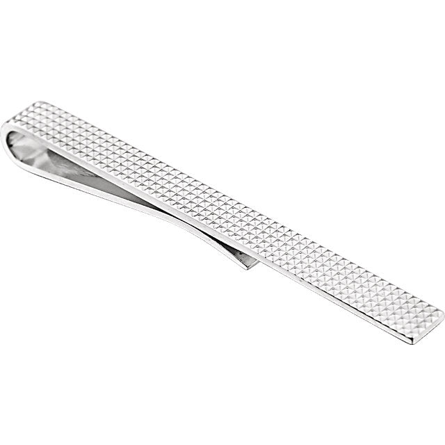 A sterling silver textured tie bar with a cool, metallic sheen and a geometric pattern.