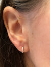 Close-up of Jessica Jewellery's diamond huggies showcasing their intricate settings.